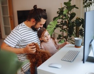 Father and daughter working together at home