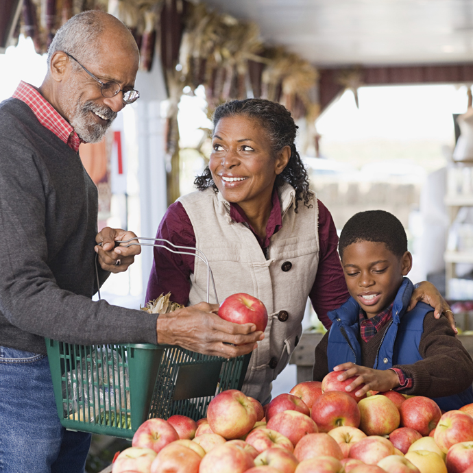 Grandparents-child-apples.jpg Grandparents with grandchild at market