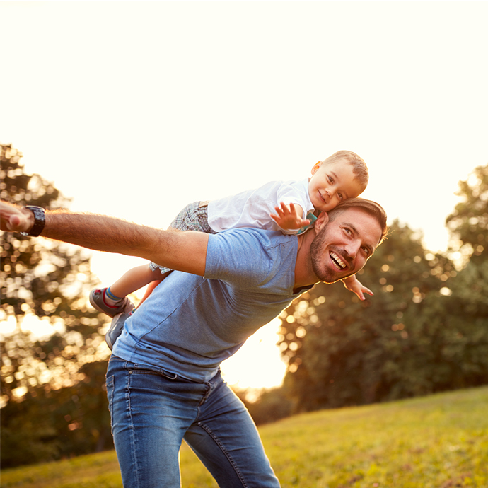 Man playing games outside with his child