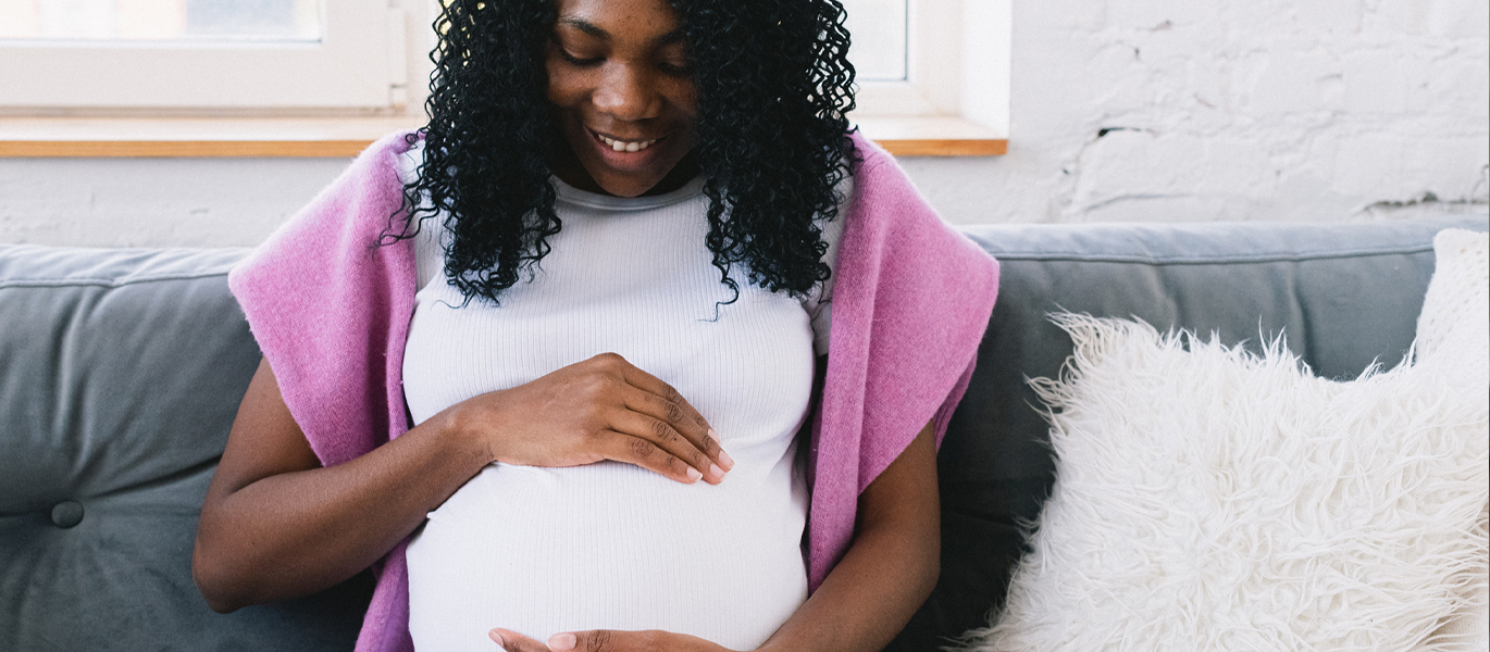 Pregnant woman holding her belly