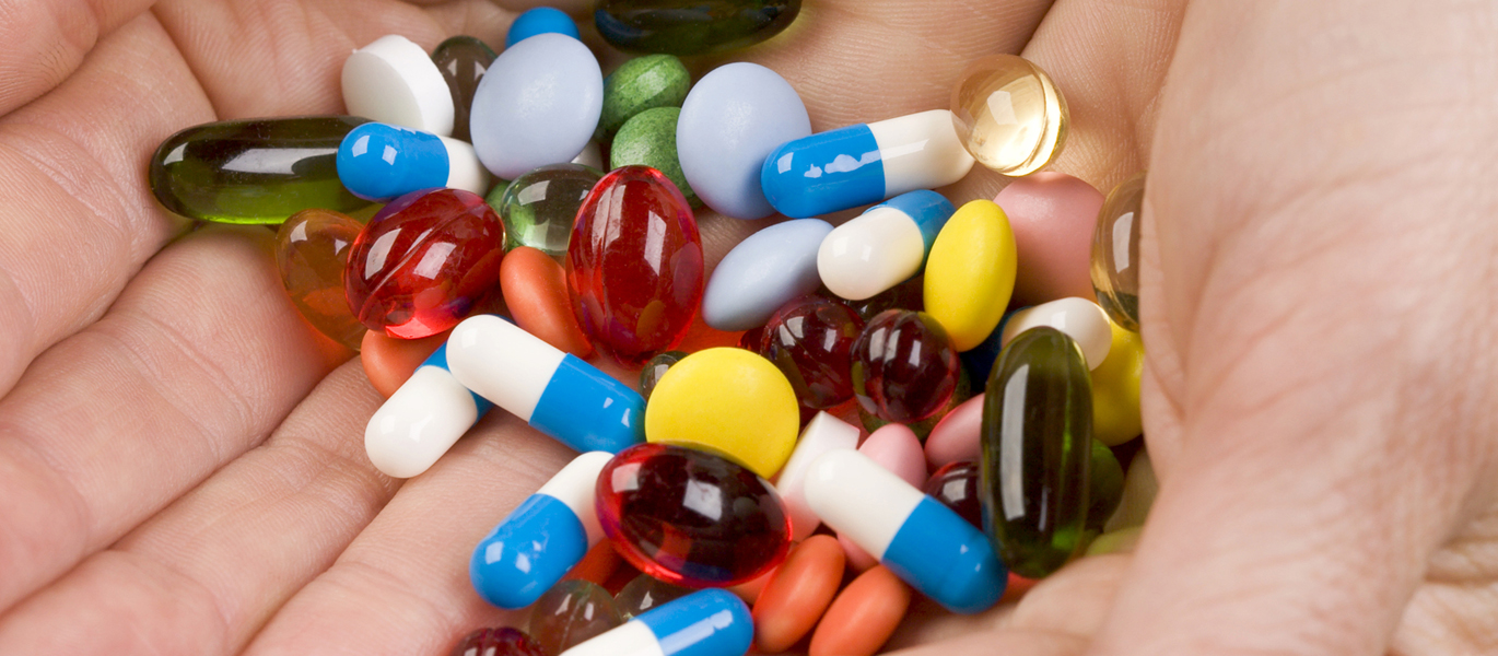 BlueRx.jpg Pharmacist hold medication pills