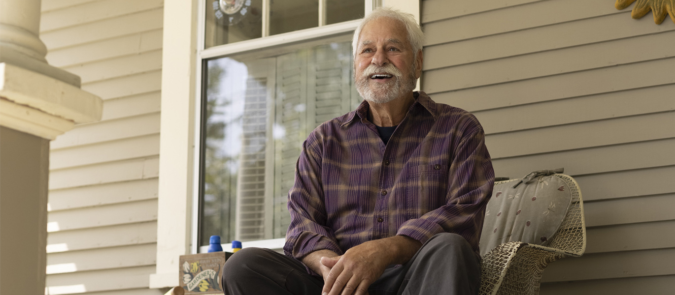 Elderly man sitting on his porch