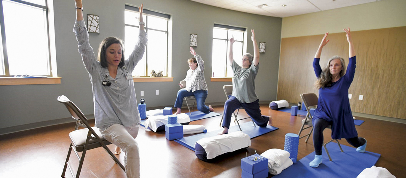 group-stretching.jpg Group yoga session to help patients with their pain