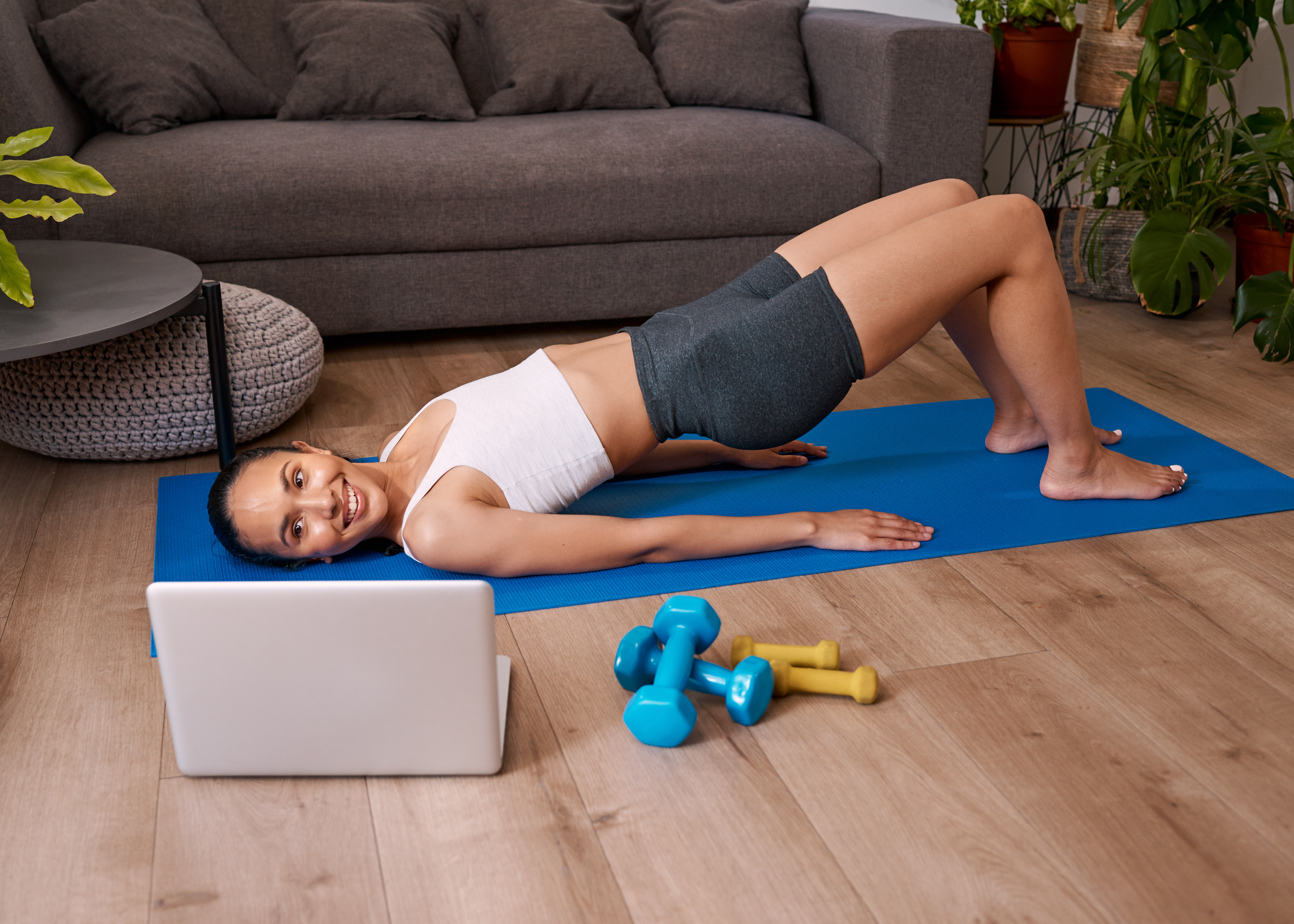 BridgeExercise.jpg Woman doing bridge exercise while watching video