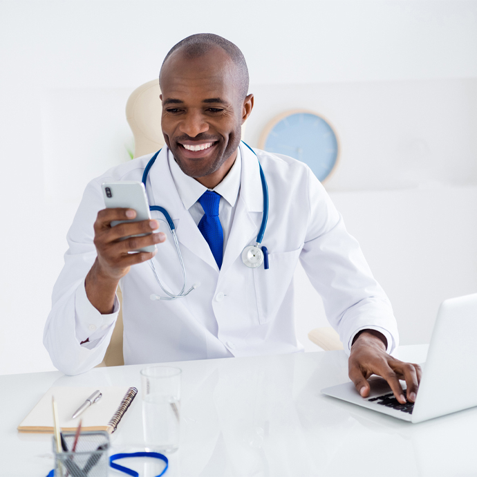 Providers on his computer and phone.jpg Provider on his computer and phone