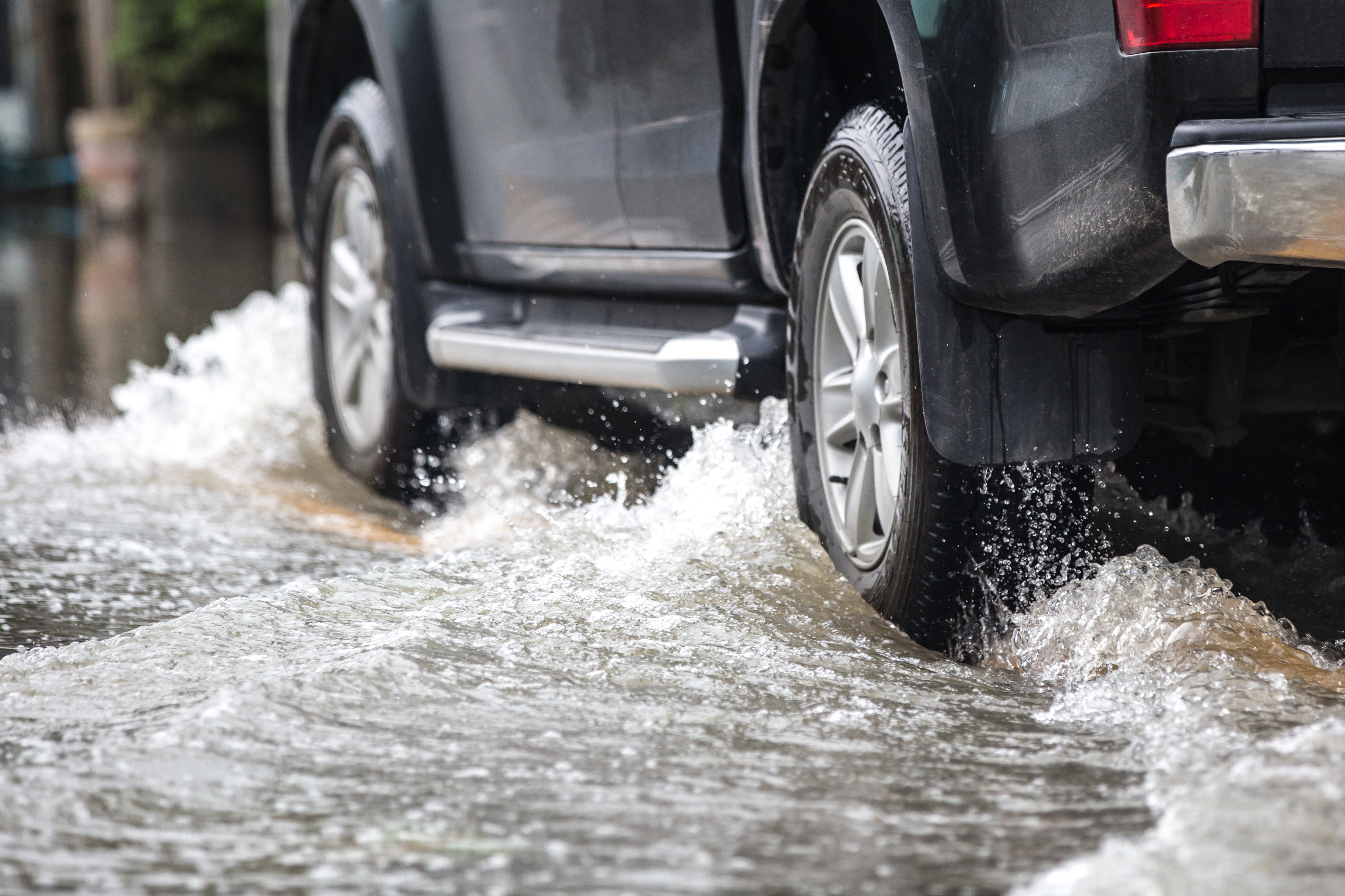 Car driving through flood waters