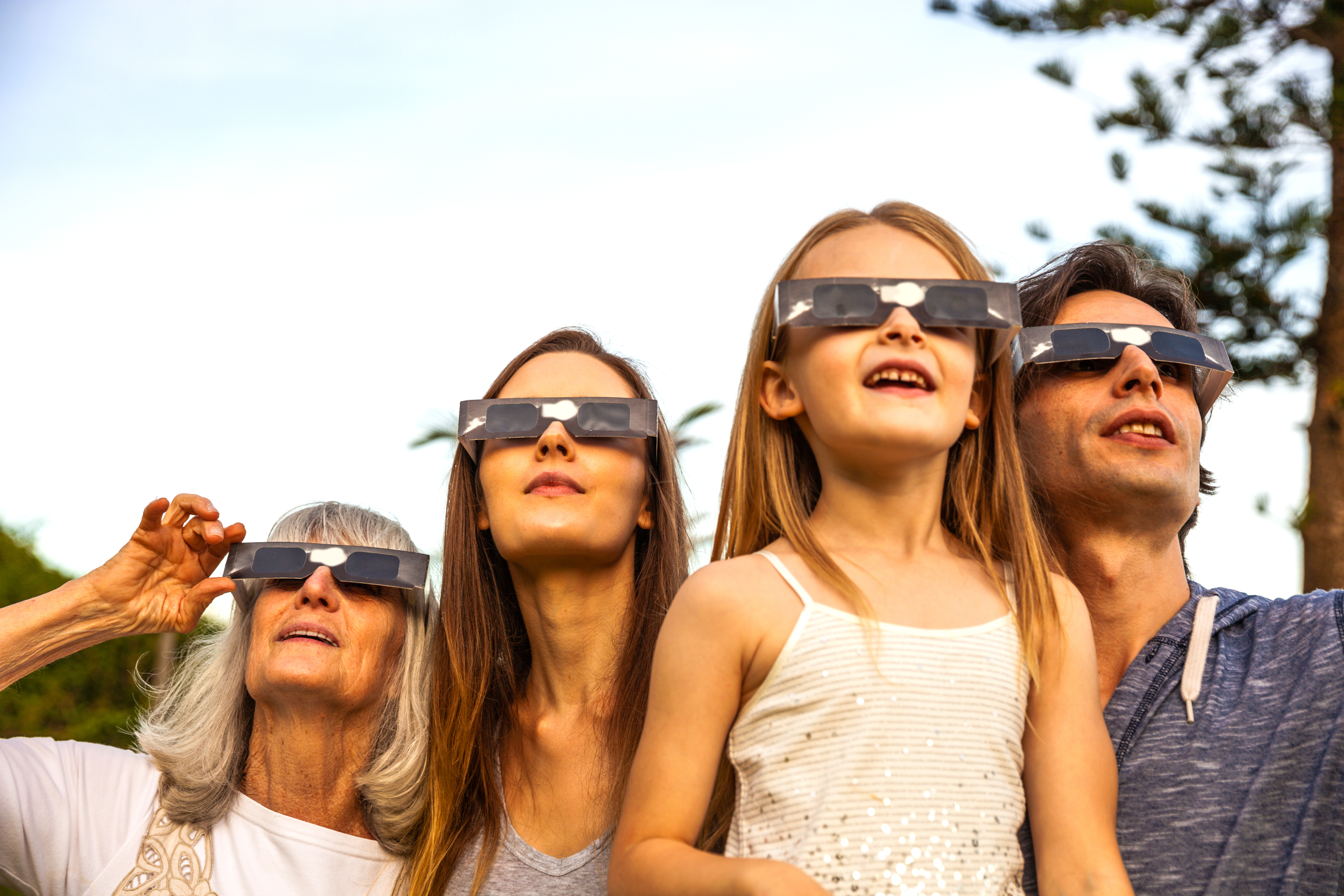 Family wearing eclipse glasses