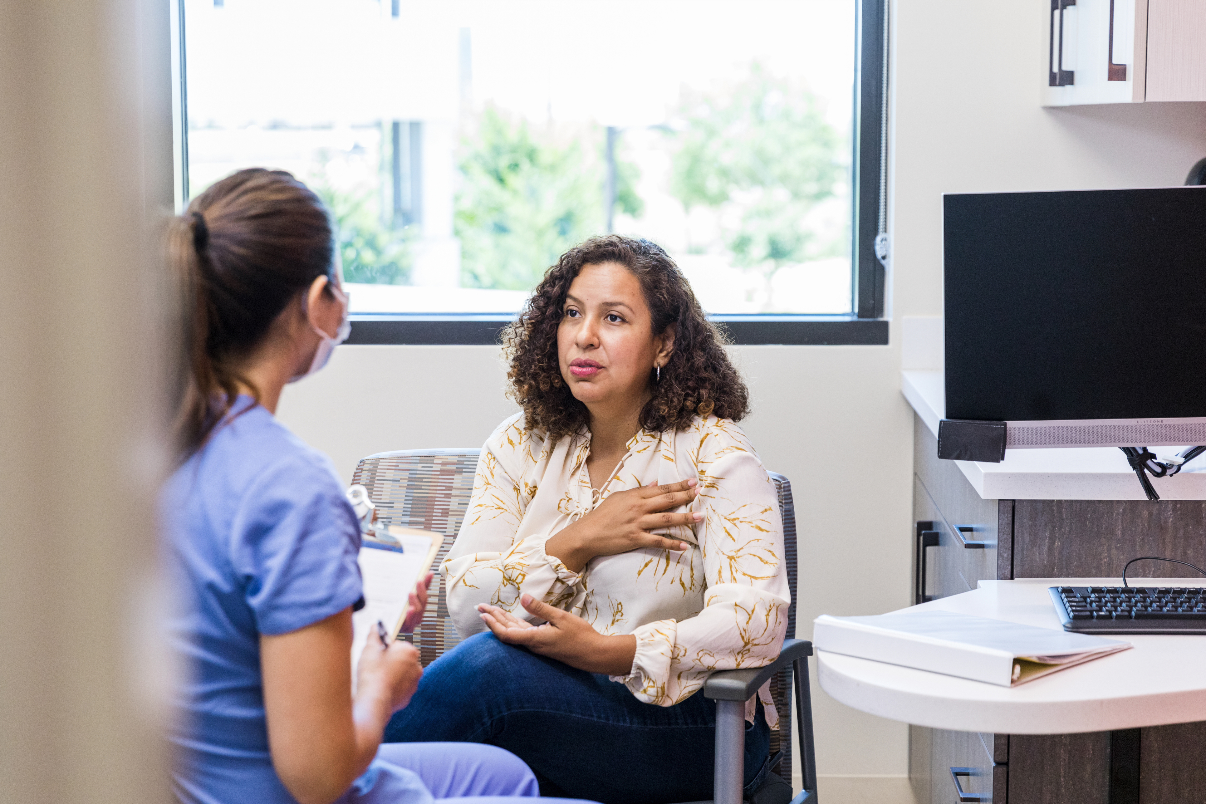 Adult female patient talks with nurse