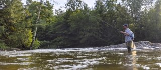 man fly fishing in the river