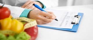 Fruit and veggies next to doctor with a clipboard