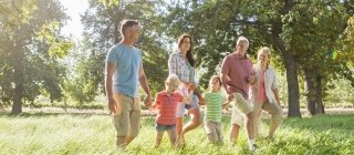 family taking a walk in a field