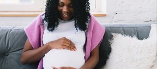 Pregnant woman holding her belly