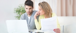 A couple reviewing their Summary Health Plan Payments document