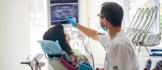 Dentist with patient during dental exam