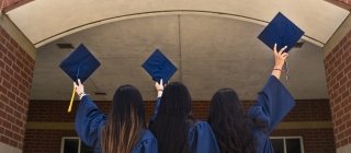 Three college graduates celebrating