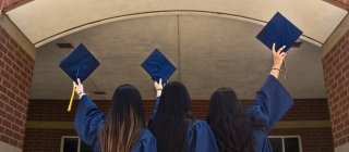 Three college graduates celebrating 