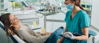 Dental hygienist talking with patient