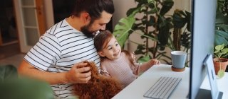 Father and daughter working together at home