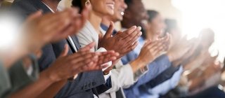 Employees clapping together