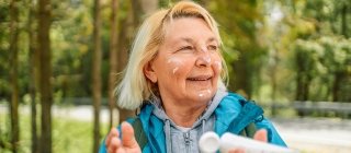 Woman applying sunscreen during a hike