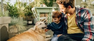 A parent and child with their dog