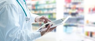 Doctor using iPad in Pharmacy