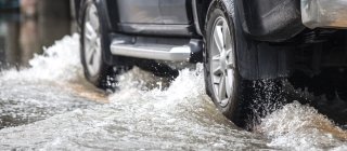 Car driving through flood waters