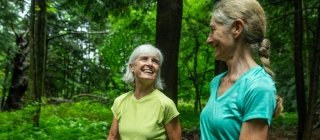 Two women walking in the woods in Vermont