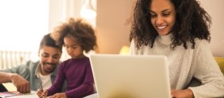 Mother working from home while dad and daughter having fun laptop computer work family