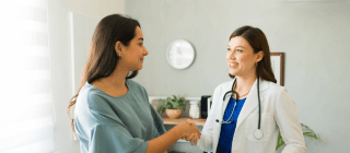 patient shaking hands with her new doctor