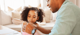 dad talking to child about money with piggy bank