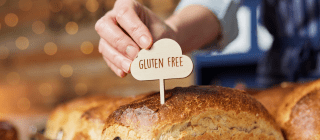 Baker placing a "Gluten-Free" sign on bread