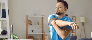 man stretching while sitting