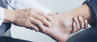 podiatrist holding patient's foot