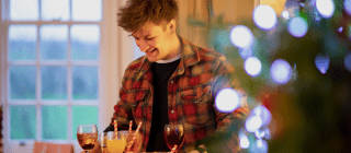 man serving non alcoholic festive drinks to his friends