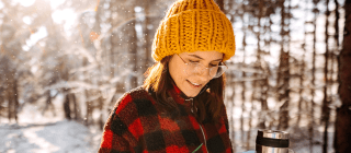 woman using her phone outside during winter