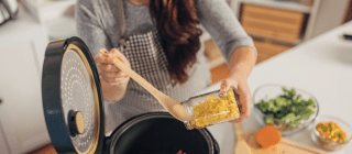 woman preparing a meal with a slow cooker 