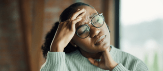 woman holding her head during a migraine