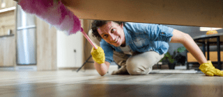 Man dusting under a bed