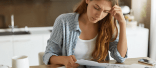woman looking at bills