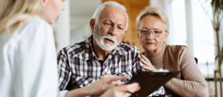senior couple looking at clipboard