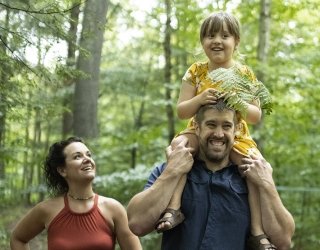 family walking in the woods