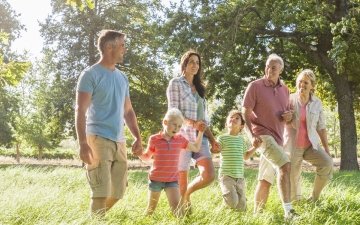 family taking a walk in a field
