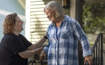 A neighbor helping an elderly neighbor