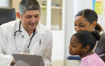 doctor talking to parent and child