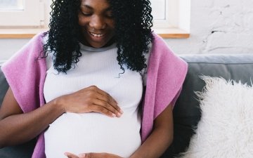 Pregnant woman holding her belly