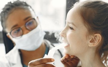 Child with asthma being checked by a doctor