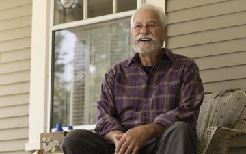 Elderly man sitting on his porch