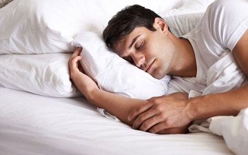 Man sleeping to cope with anxiety, sadness and other grief.