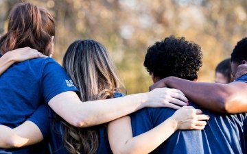 Community members huddling and showing support
